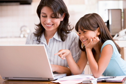 Woman and daughter at a computer