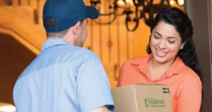 delivery man giving melaleuca box to a women