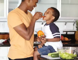 Father Feeding Son Vegetables