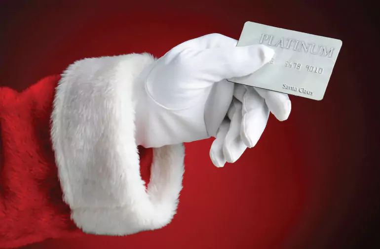 Santa's hand holding a credit card