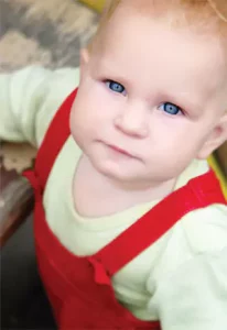 Baby in Red Overalls