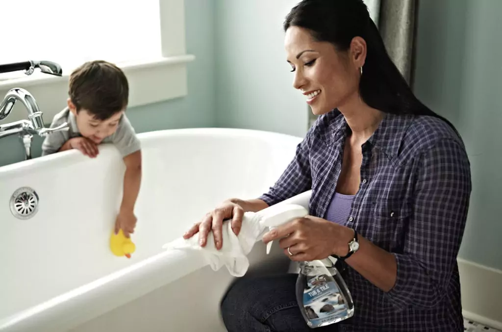 Women Cleaning with Melaleuca Products with her son playing close by