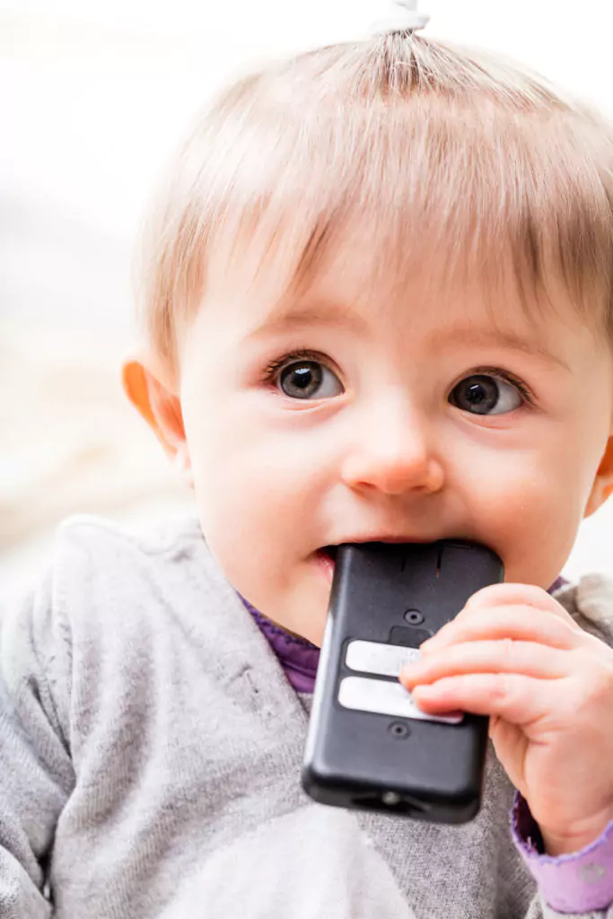 Child teething on remote