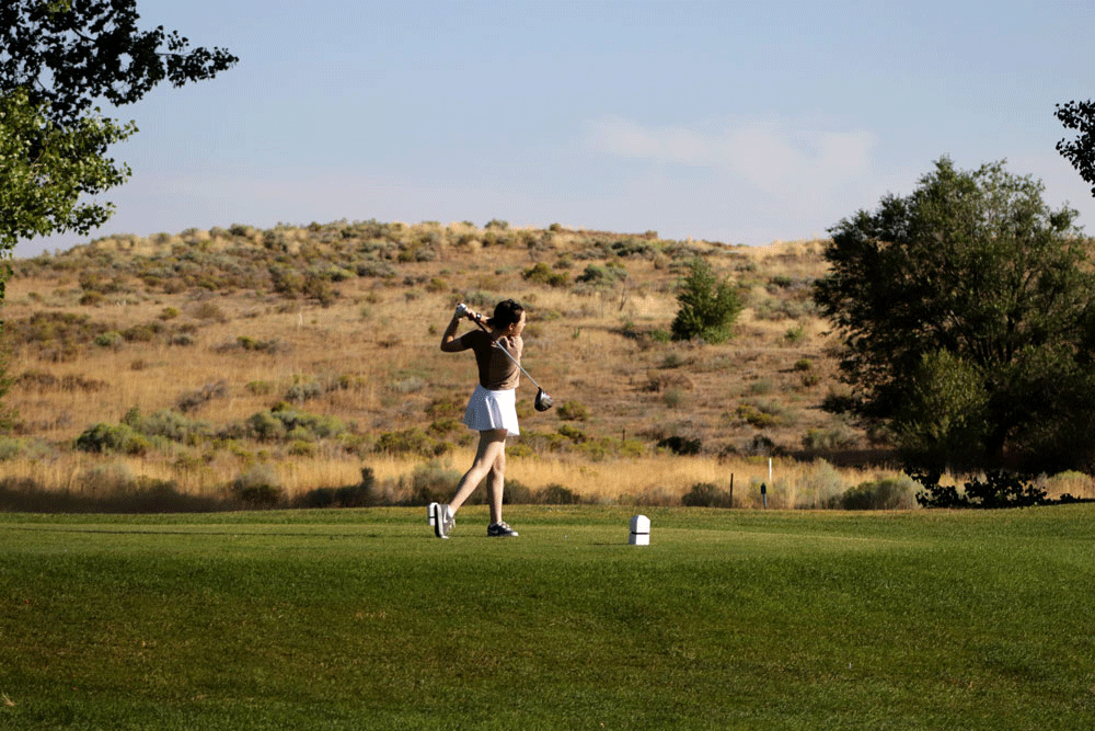 Women driving a golf ball