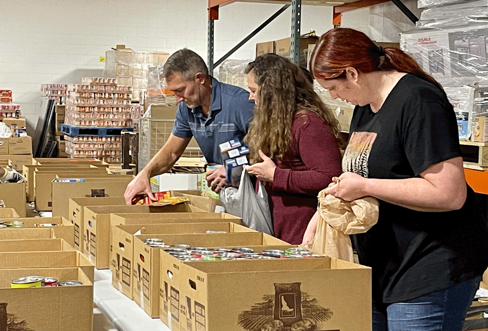 Melaleuca employees sorting food at community food basket