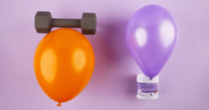 an orange balloon with an exercise weight on it, a purple balloon with Melaleuca's Mela-Out Magnesium under it.