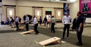 Melaleuca employees play cornhole.